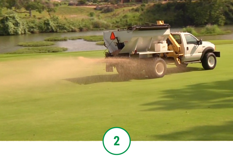 Topdressing turf to fill in any divots and imperfections